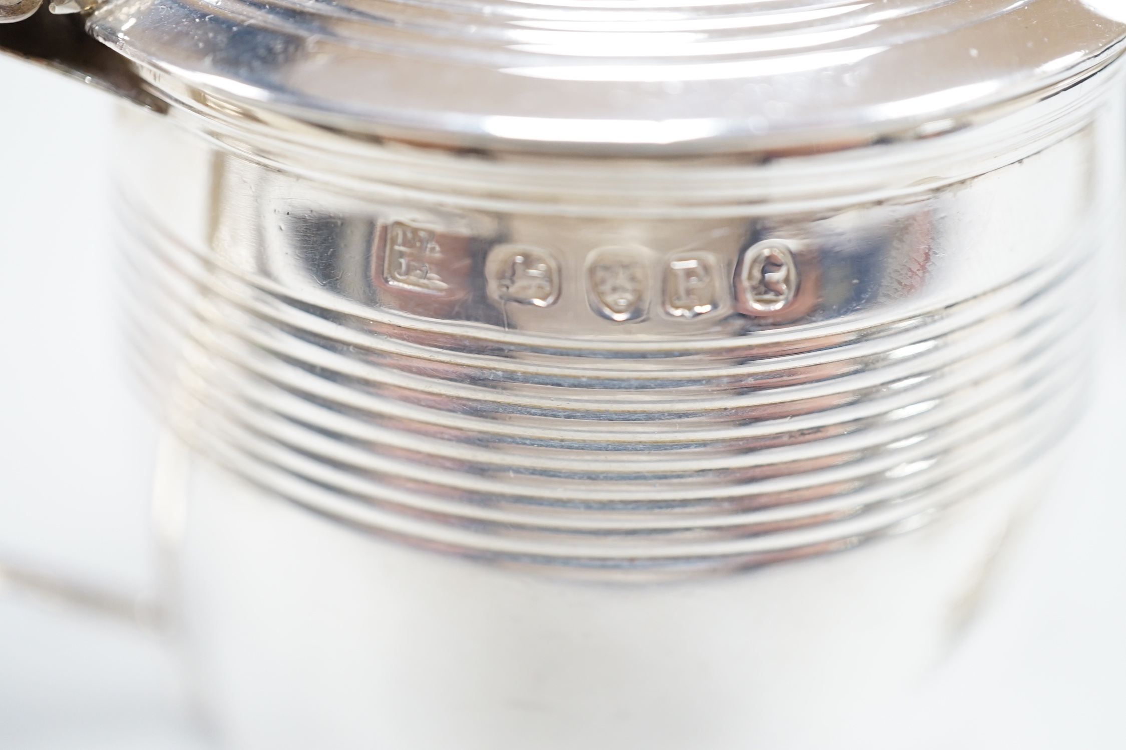A George III reeded silver barrel shaped mustard pot, London, 1810, height 78mm, a later silver mustard, pair of silver salts and a pair of silver sugar tongs.